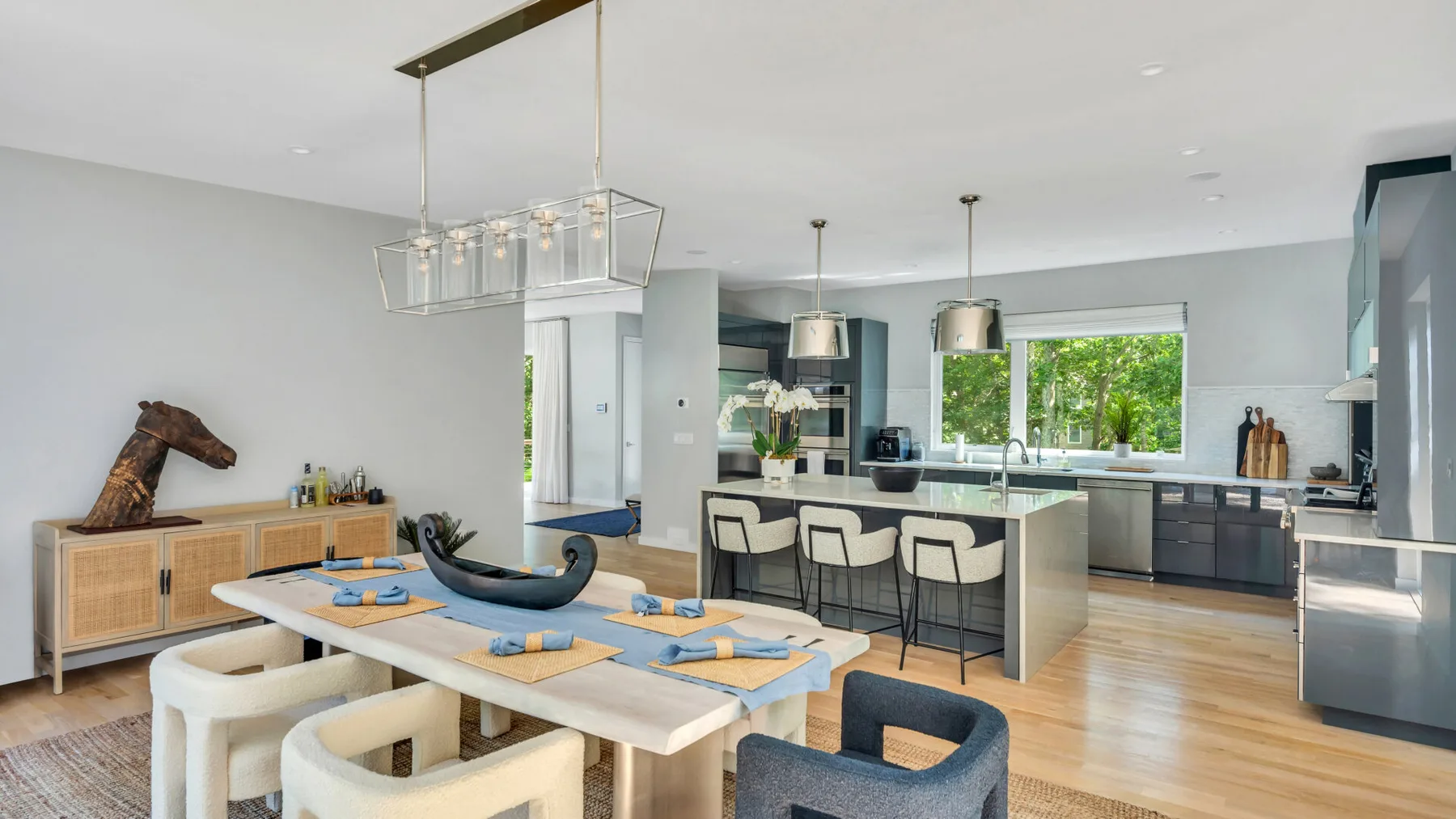 An open-plan kitchen and dining area with a long table and kitchen island.