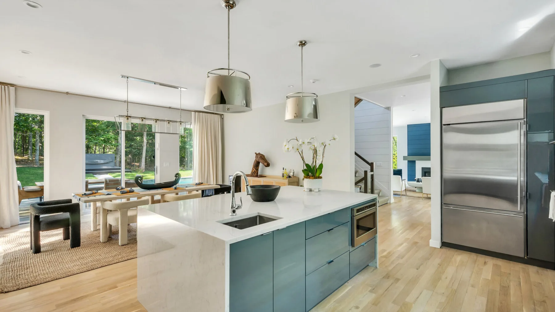 A bright open-plan kitchen and dining area with a large island and table.