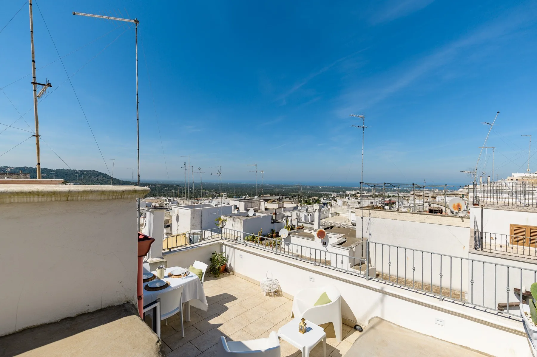 A rooftop terrace with outdoor seating and views across the surrounding rooftops.