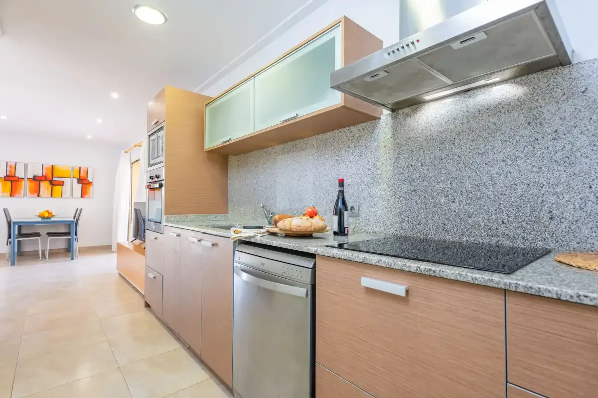 Una cocina moderna con encimera, placa de cocina y horno integrado.
