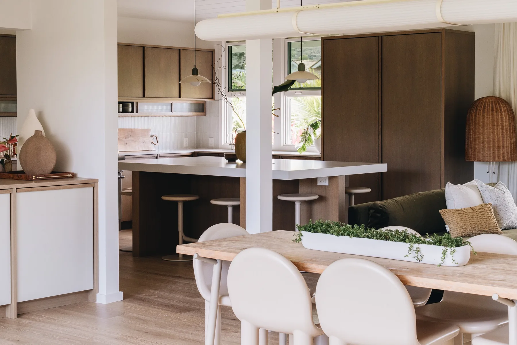 An open-plan kitchen and dining area with a long island and table.