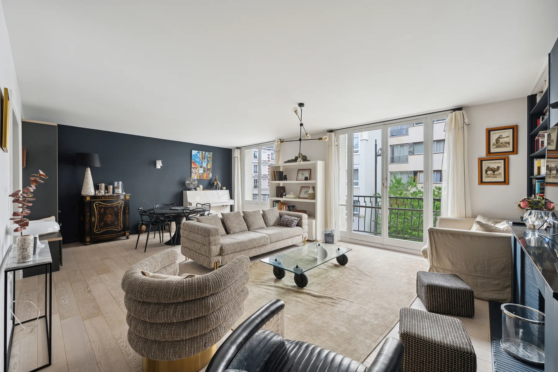 A bright living room with seating arranged around a low coffee table.
