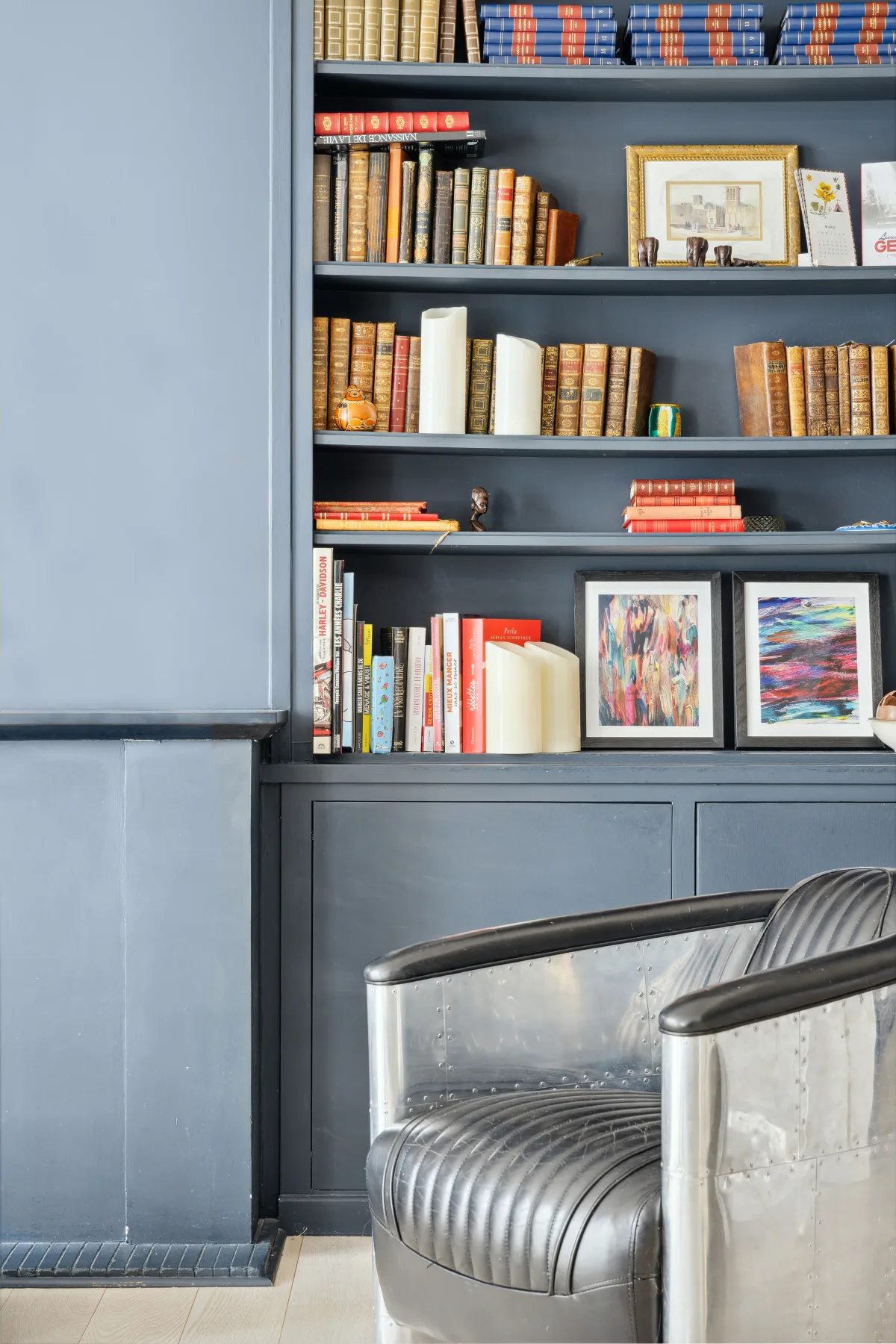 A reading nook with bookshelves and upholstered seating.