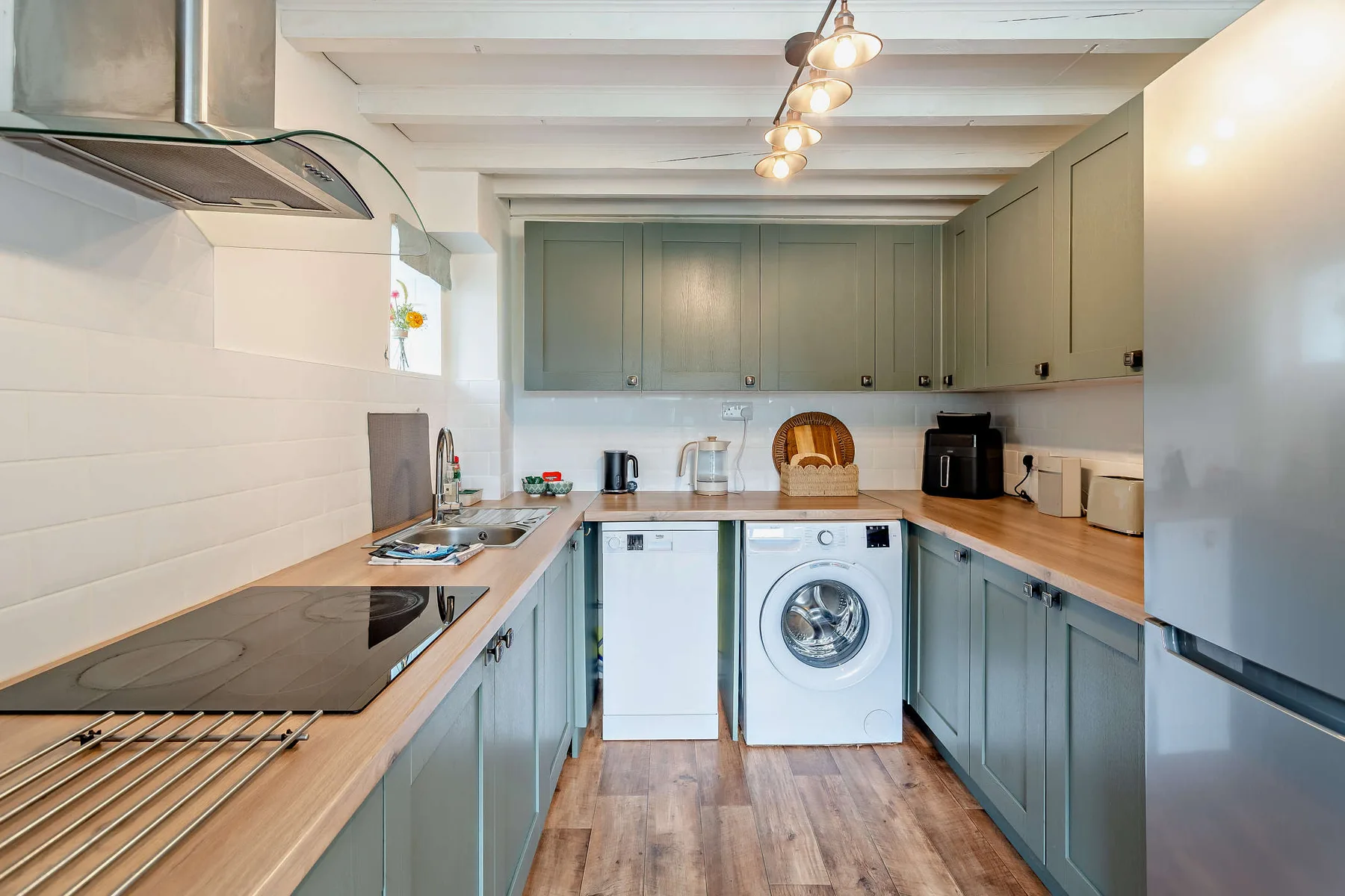 A fitted kitchen with a washing machine beneath the counter.