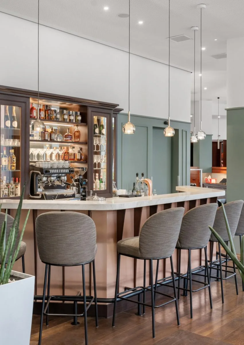Bar with seating and illuminated drinks shelves