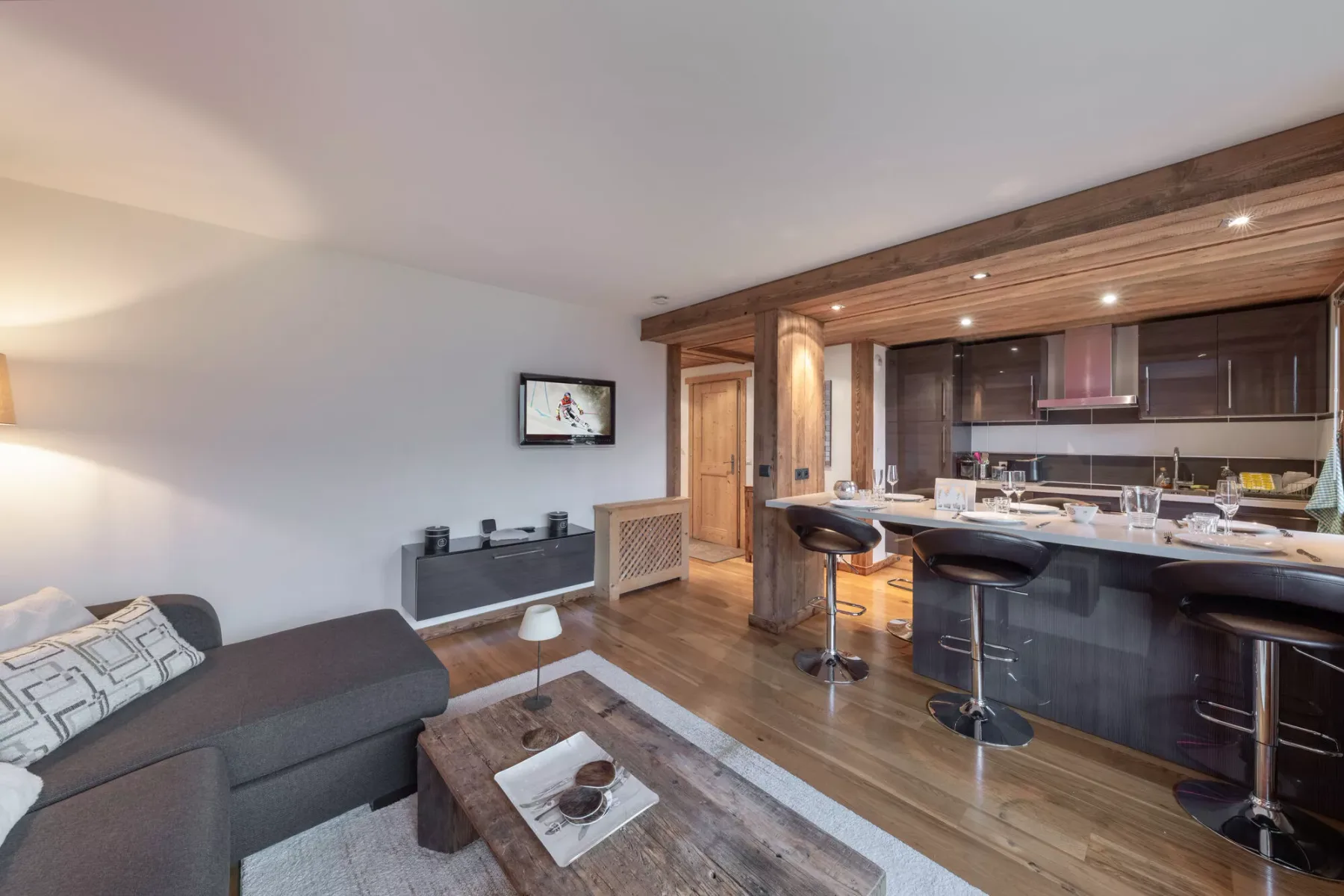 An open-plan living and kitchen area with a counter and seating.
