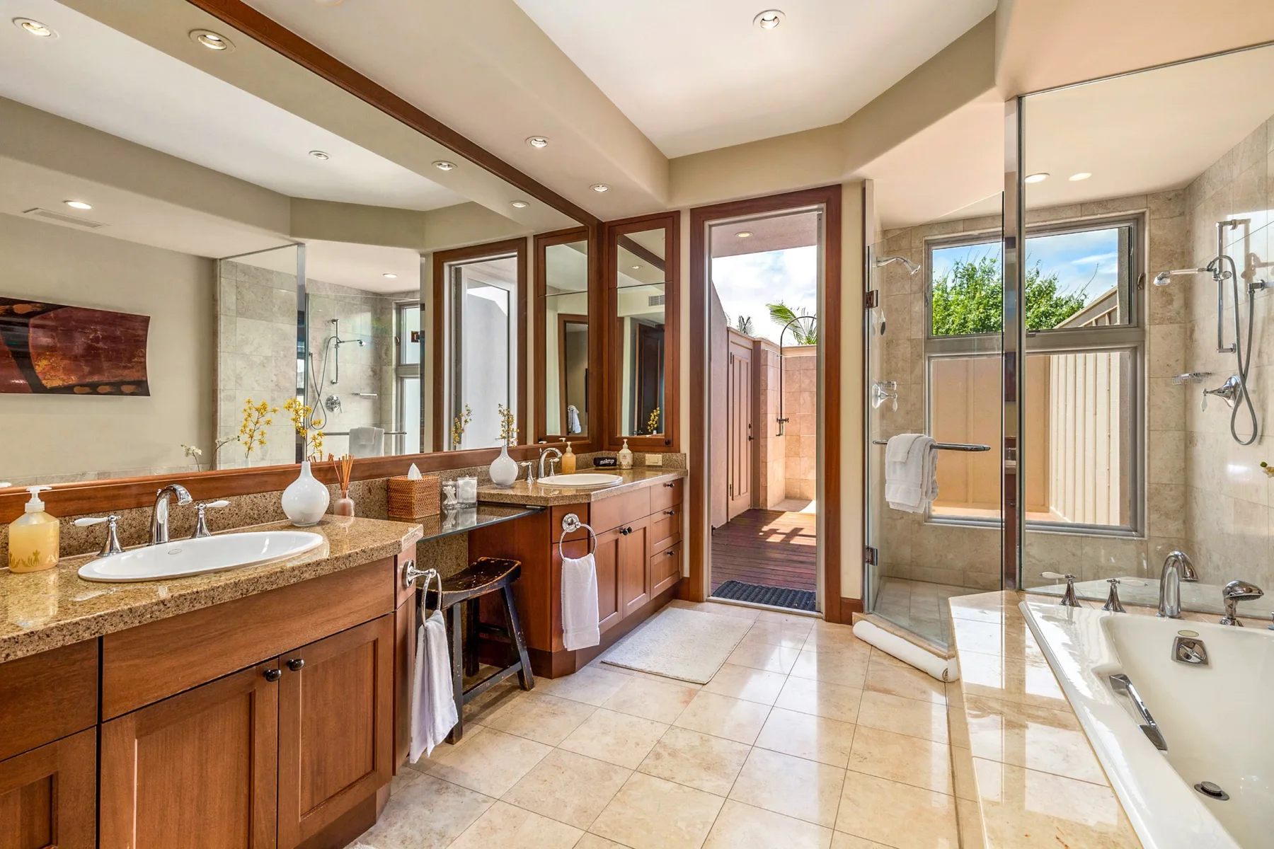 A spacious bathroom with a long vanity, walk-in shower, and bathtub.