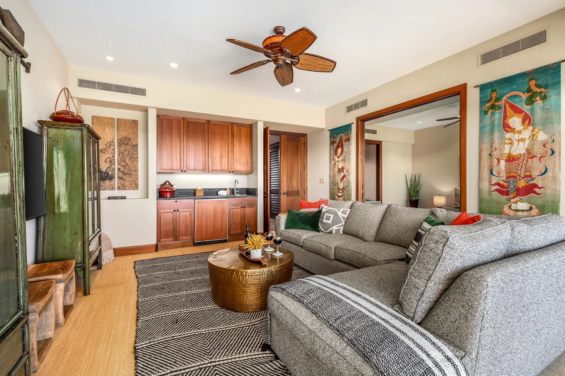 A living room with gray seating, a wooden coffee table, and built-in cabinetry.