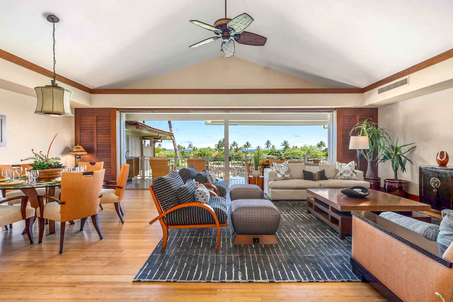 A bright living and dining area opens onto a patio through wide sliding glass doors.