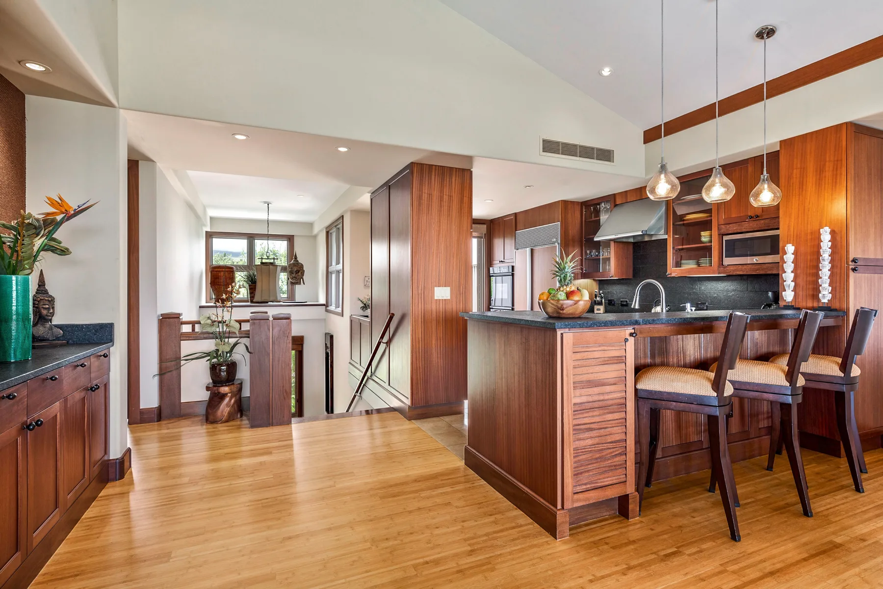 An open-plan kitchen and dining area with wooden cabinetry and a central island.