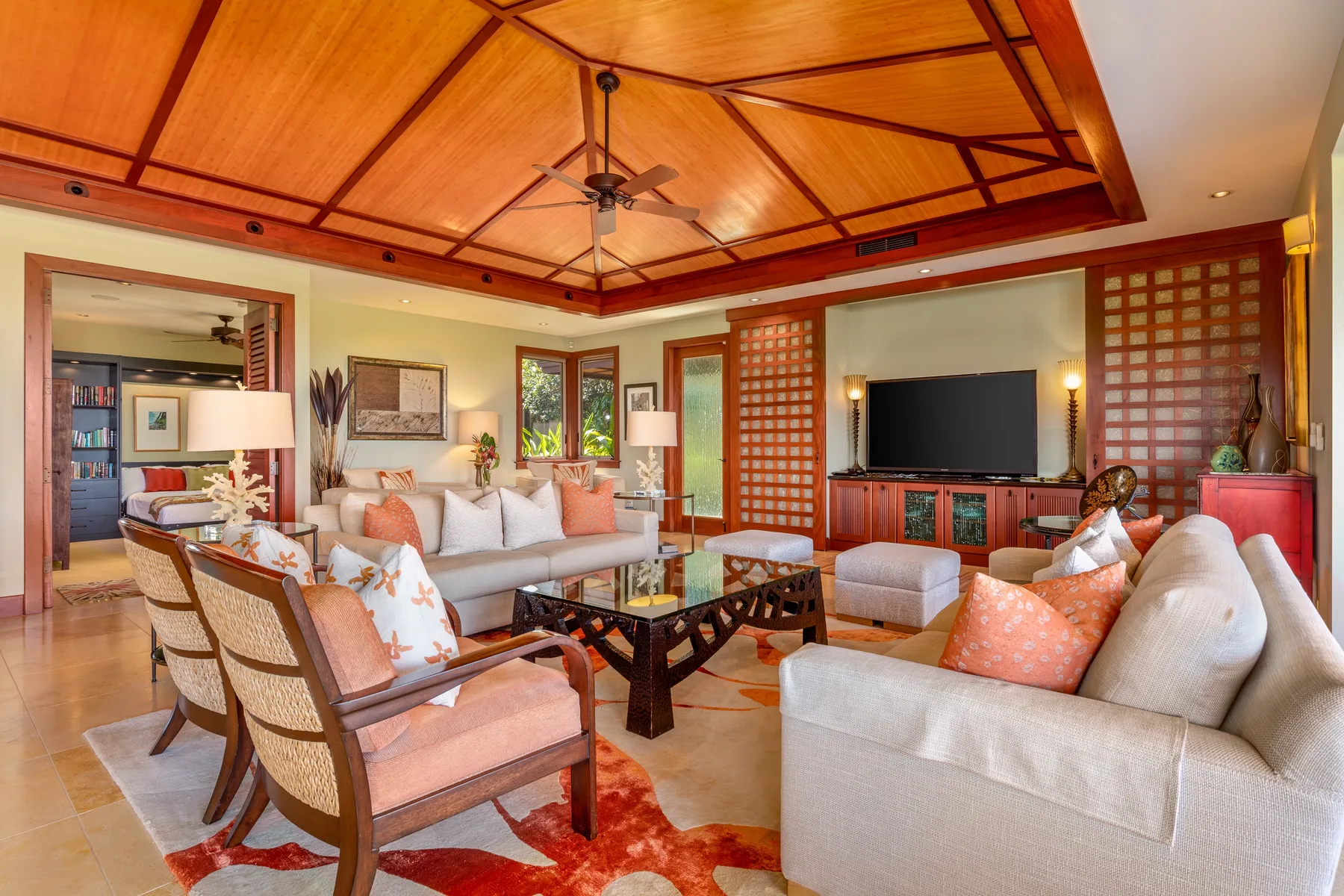 A living room with seating arranged around a coffee table and television.