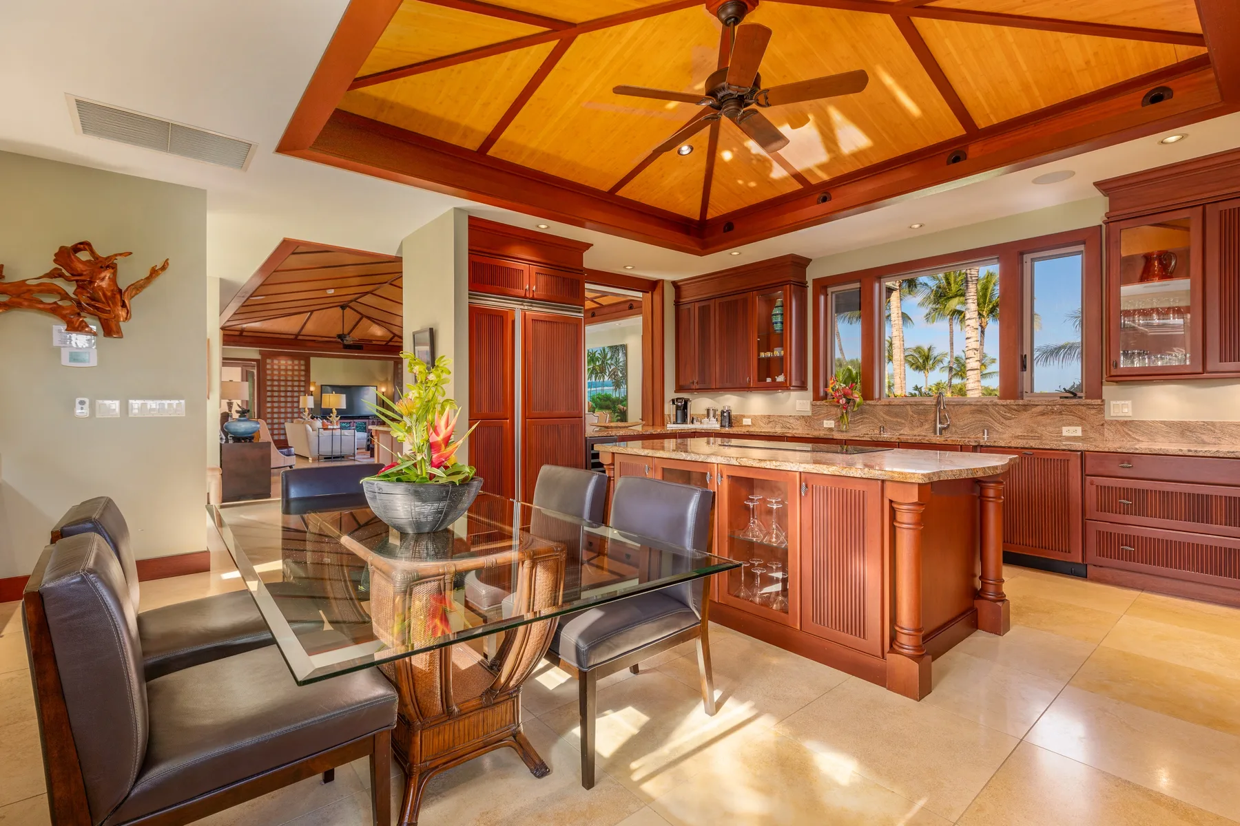 A kitchen and dining area with wooden cabinetry and a glass dining table.