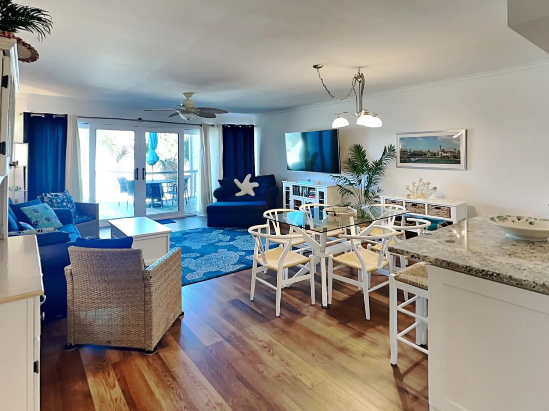 An open living and dining area with blue seating and a dining table.