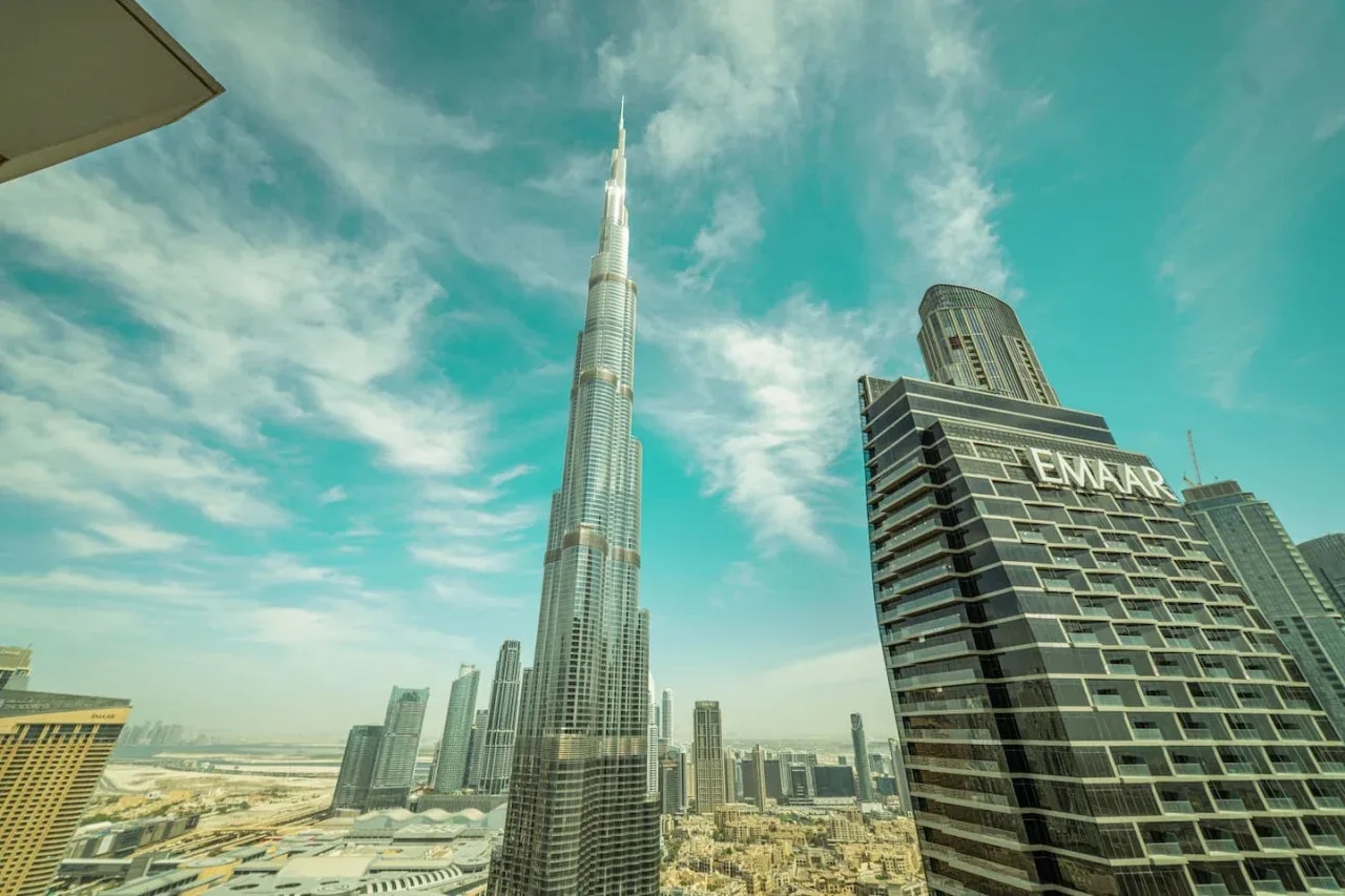 A city skyline view features the Burj Khalifa and a nearby high-rise building.