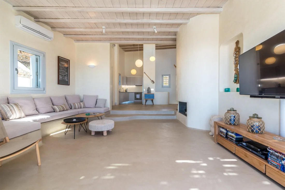 Living room with sectional seating, a coffee table, and a television.
