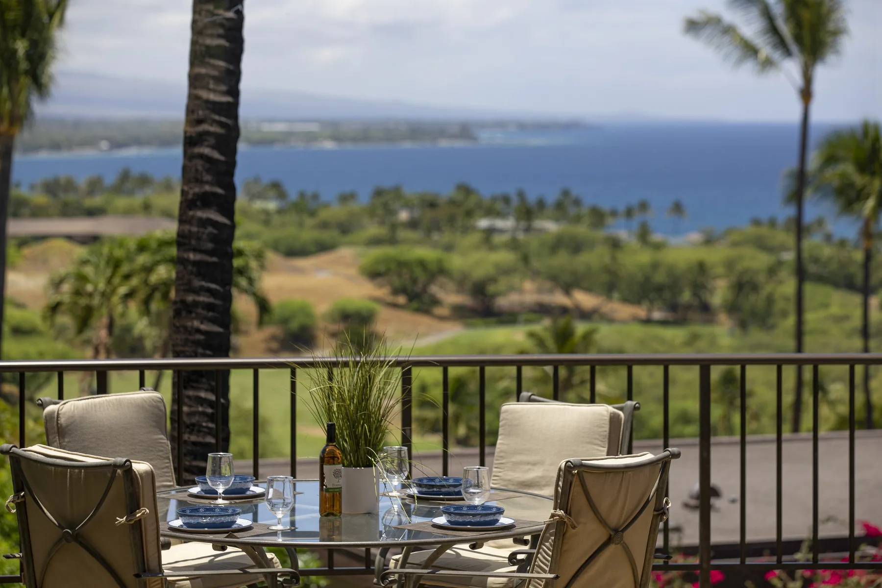 A terrace dining area overlooks a landscaped coast and the ocean.
