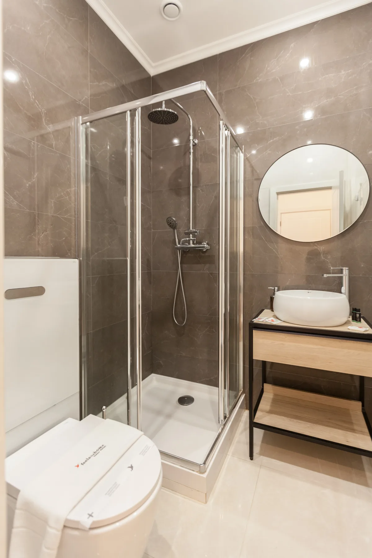 A bathroom with a shower, toilet, and sink.