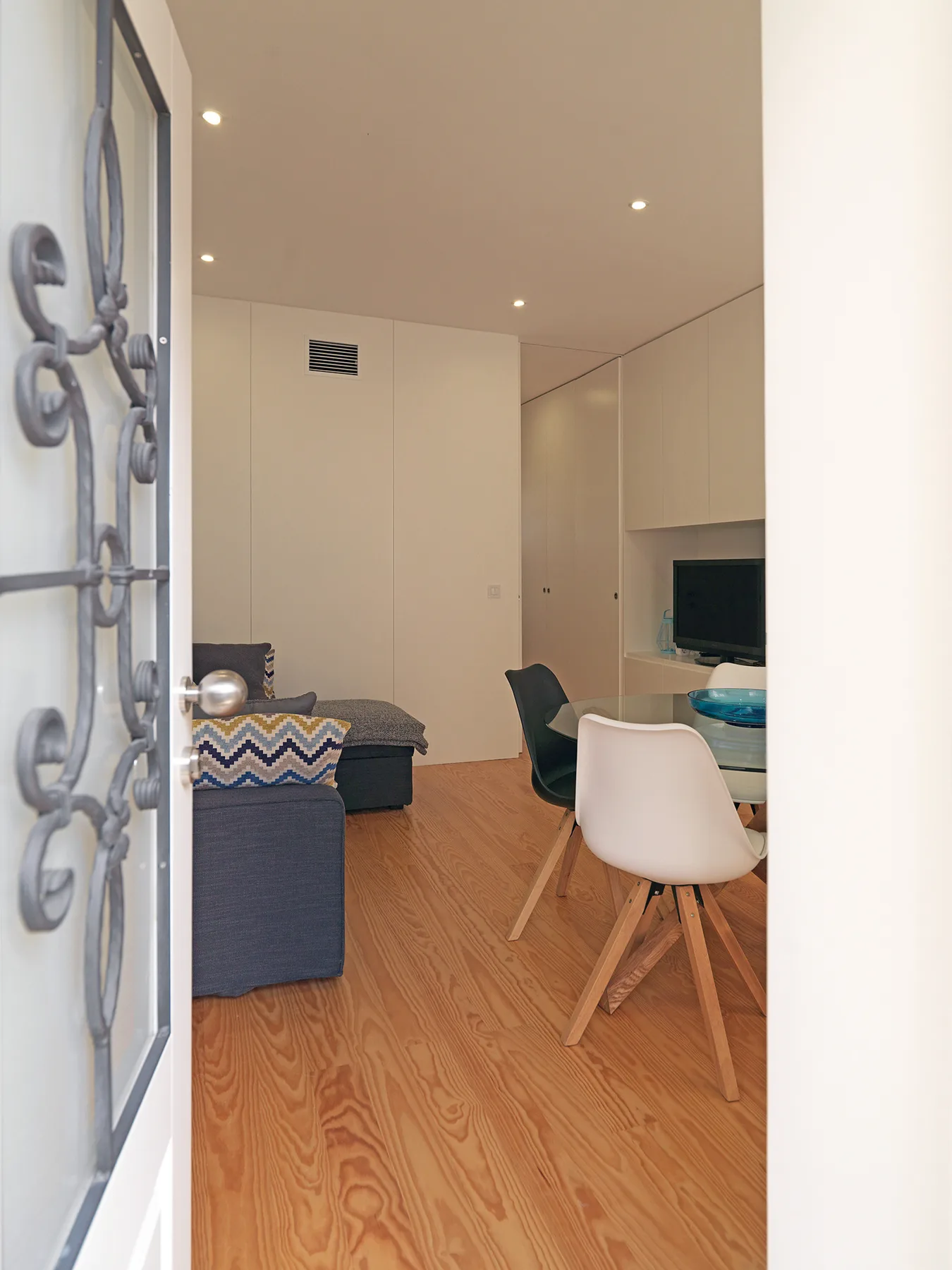 Una zona de estar moderna con asientos, una mesa de comedor y un televisor.