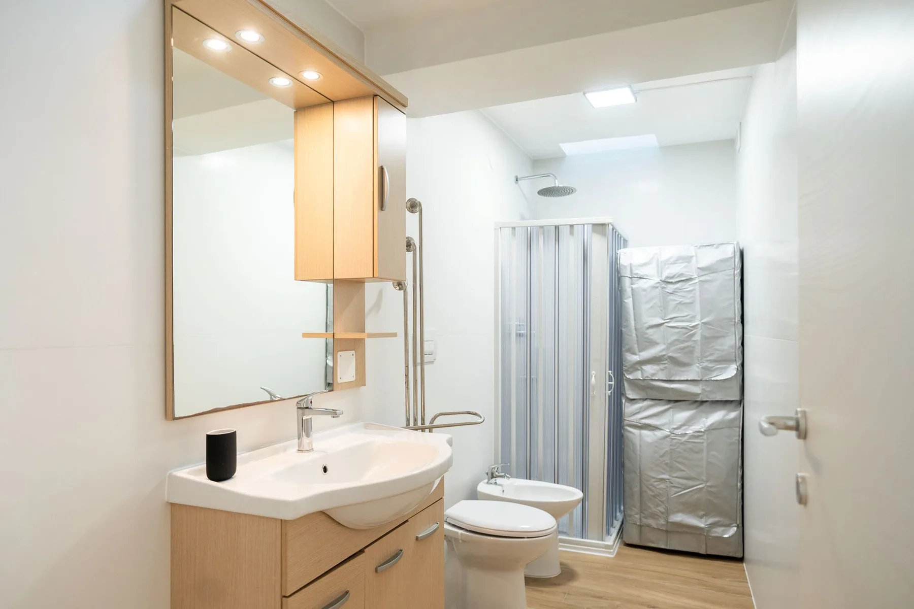A bathroom with a sink, toilet, and shower.