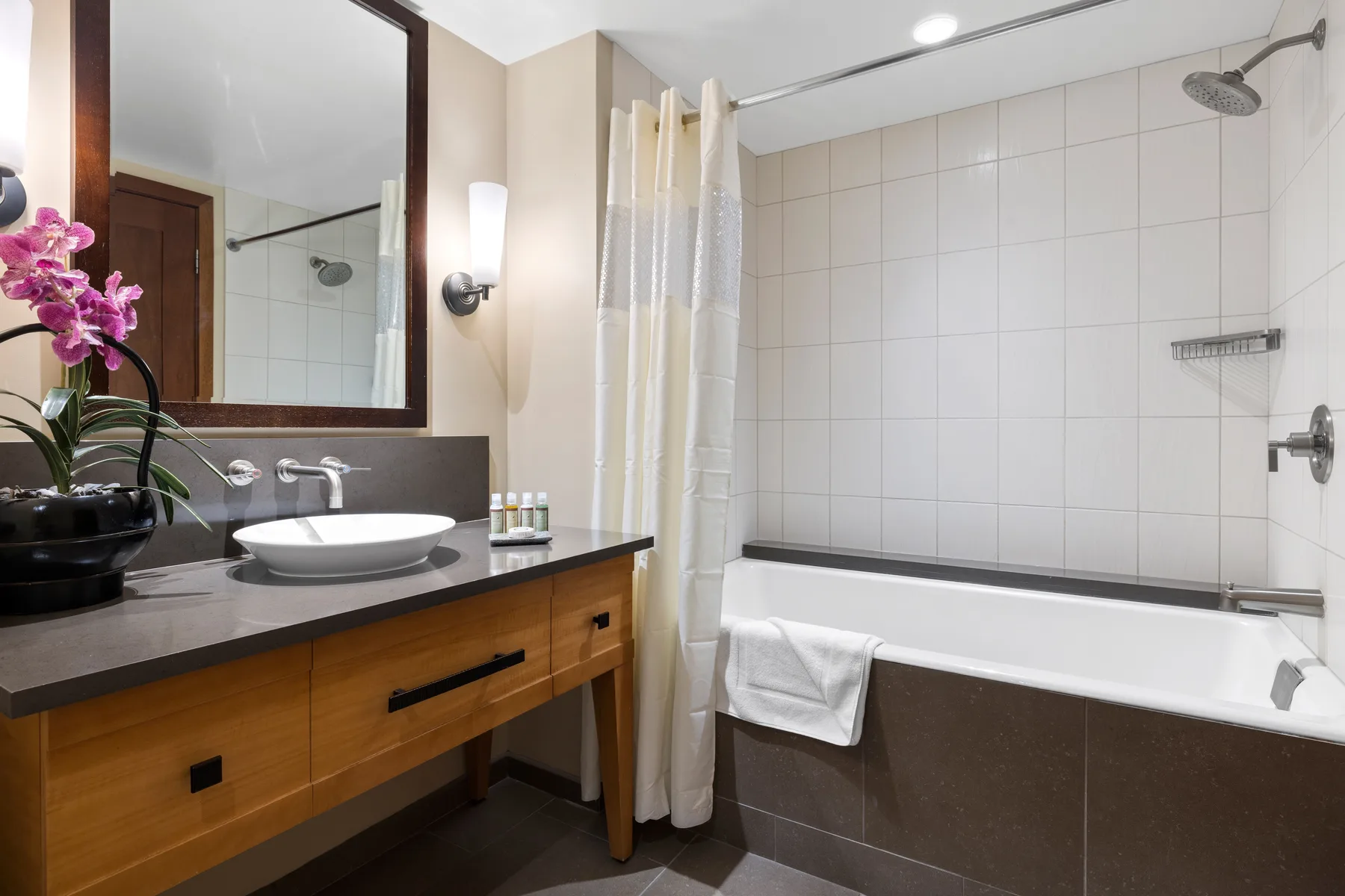 Un baño con un tocador junto a una bañera y ducha.