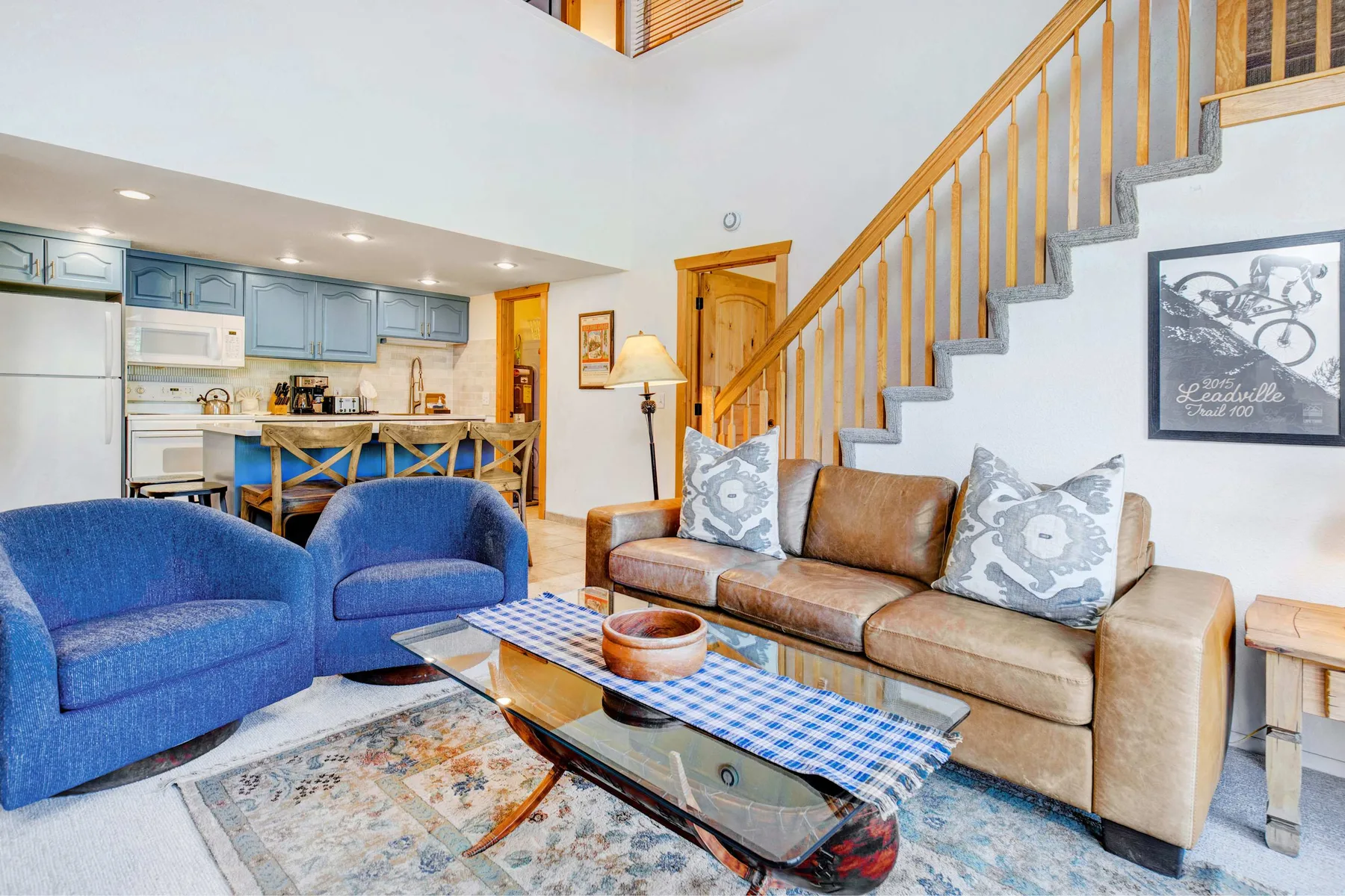 A living room with seating arranged around a glass coffee table.