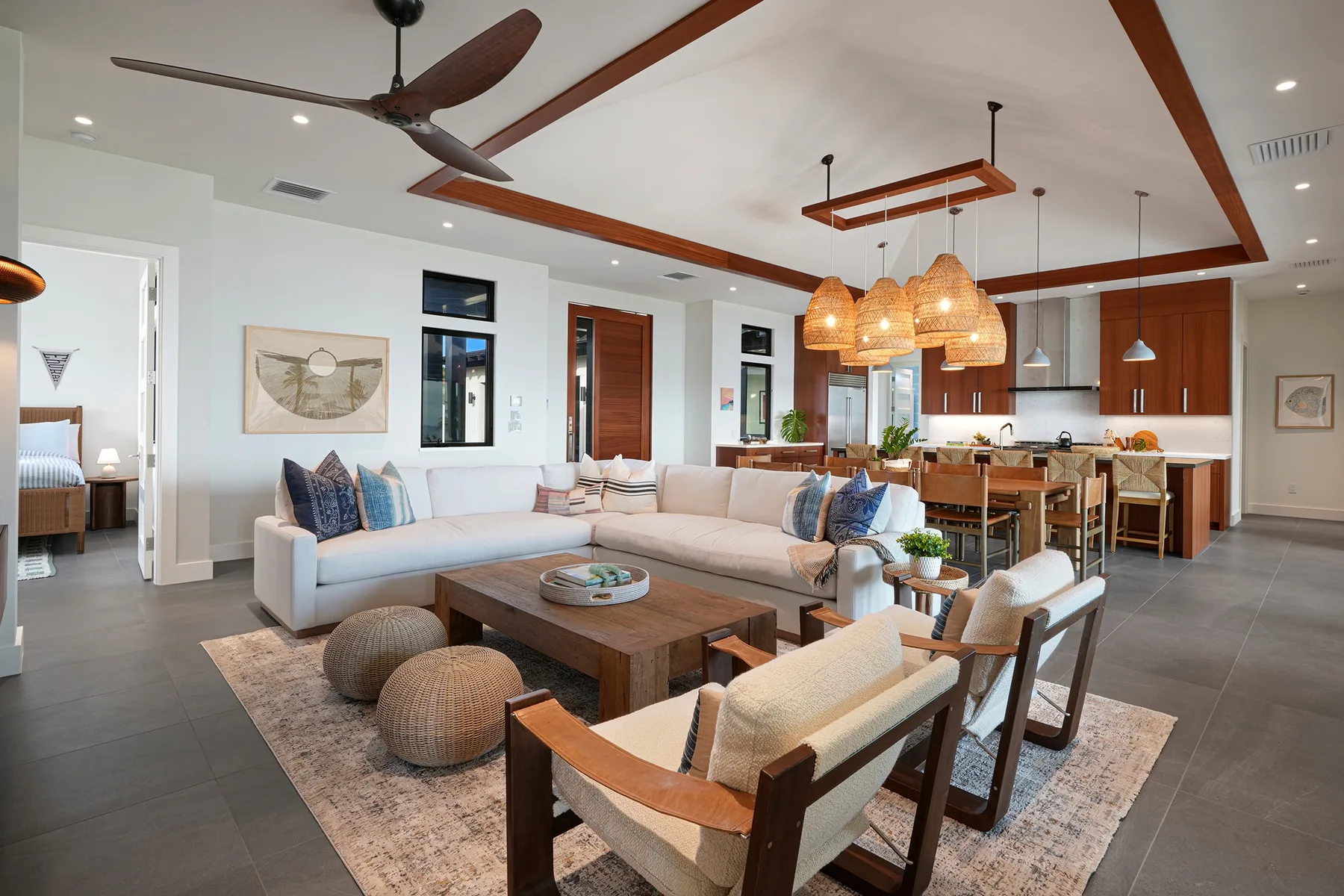 An open-plan living room and kitchen with a sectional sofa and dining area.