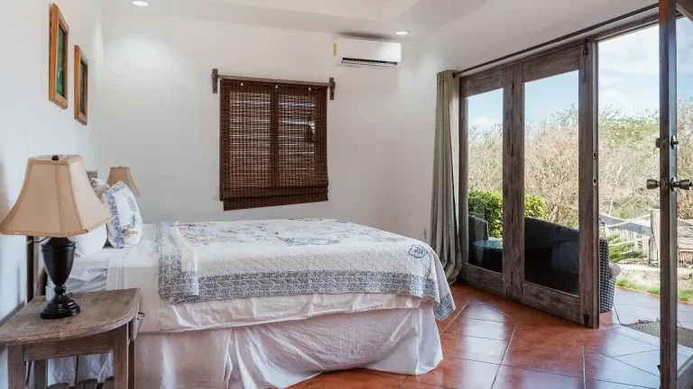 King Standard Pool View room with king bed and patio doors