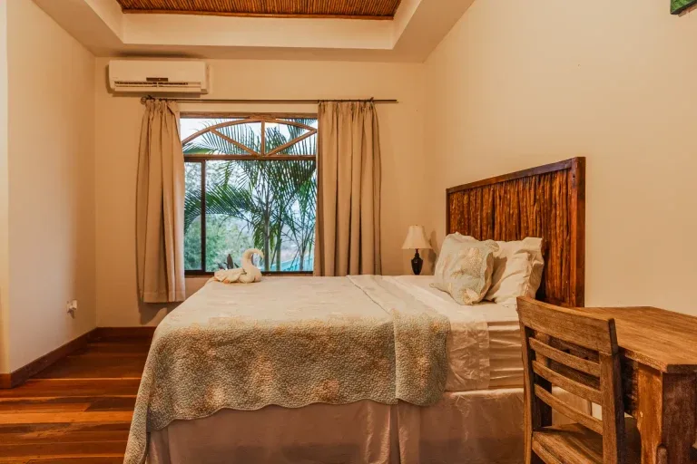 Studio sleeping area with two beds and balcony