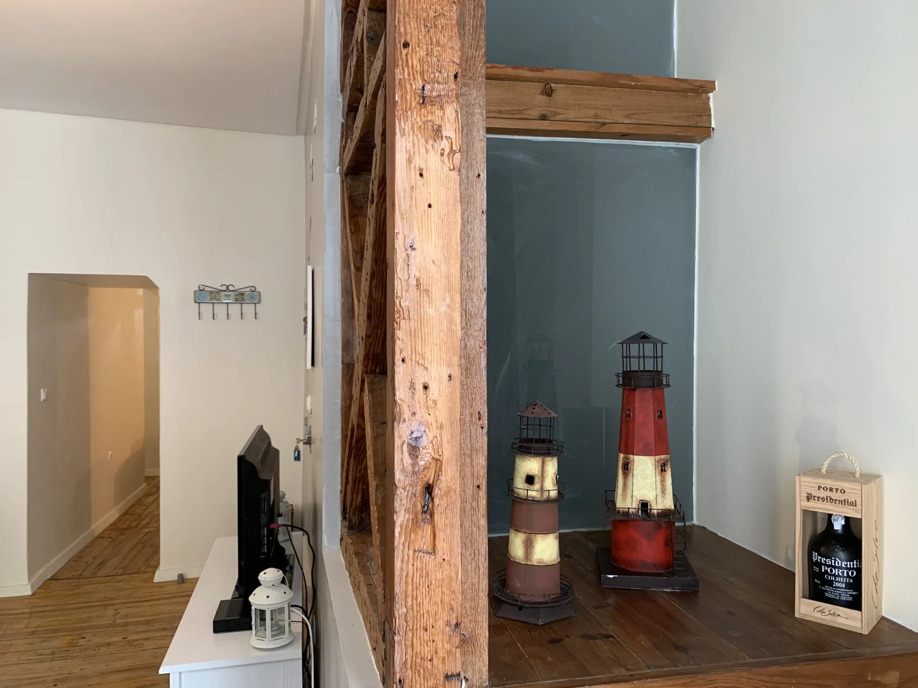 A living area with a television and decorative lighthouse models on a table.