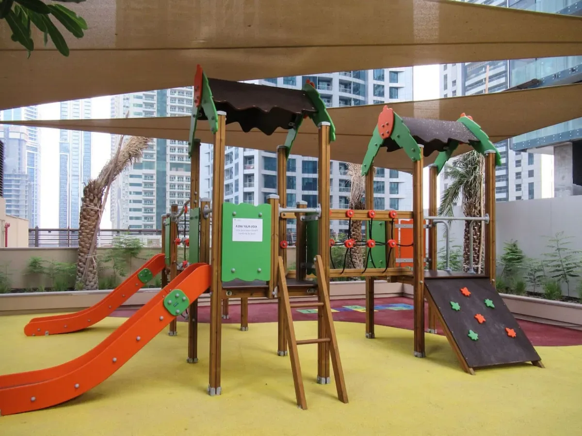 A colorful outdoor playground with slides and climbing equipment.