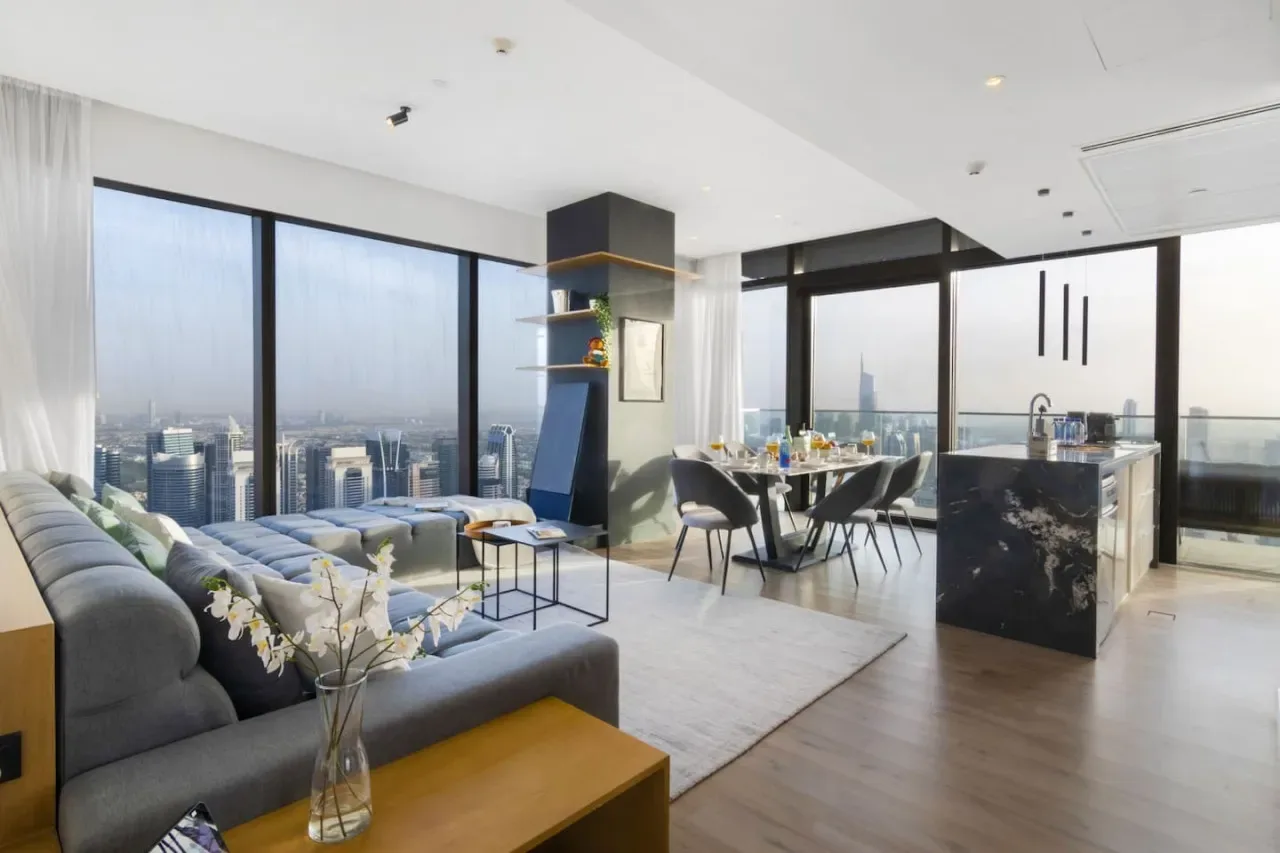 A bright open-plan living and dining area has large windows overlooking the city.