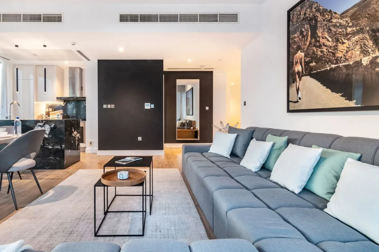 A modern living room with a gray sectional and a coffee table.