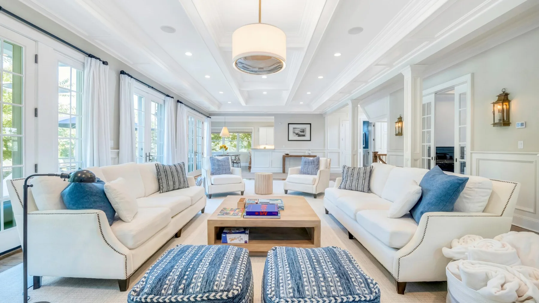 A bright living room with facing seating and a low table.