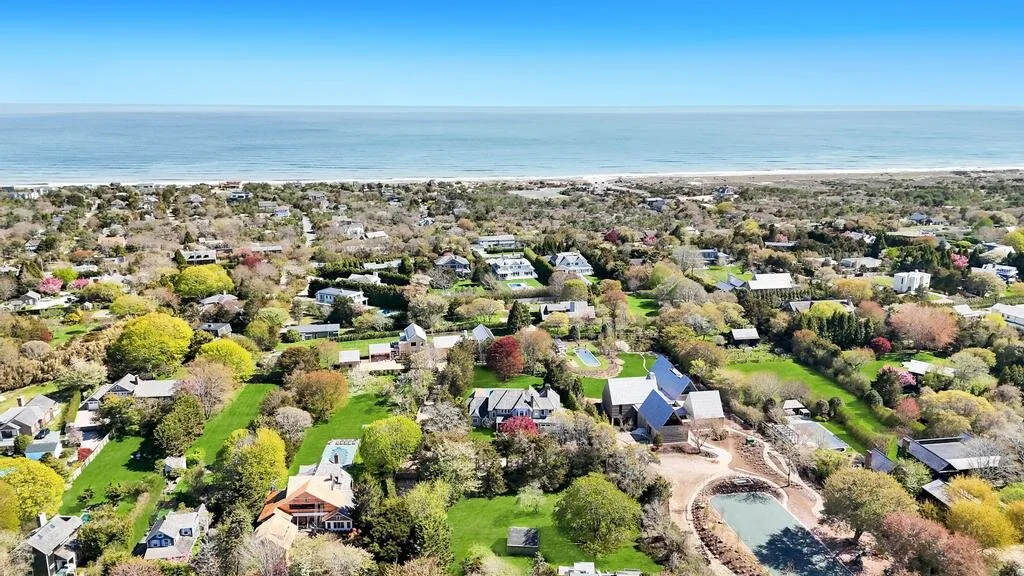 Aerial view of a coastal neighborhood with the ocean visible in the distance.