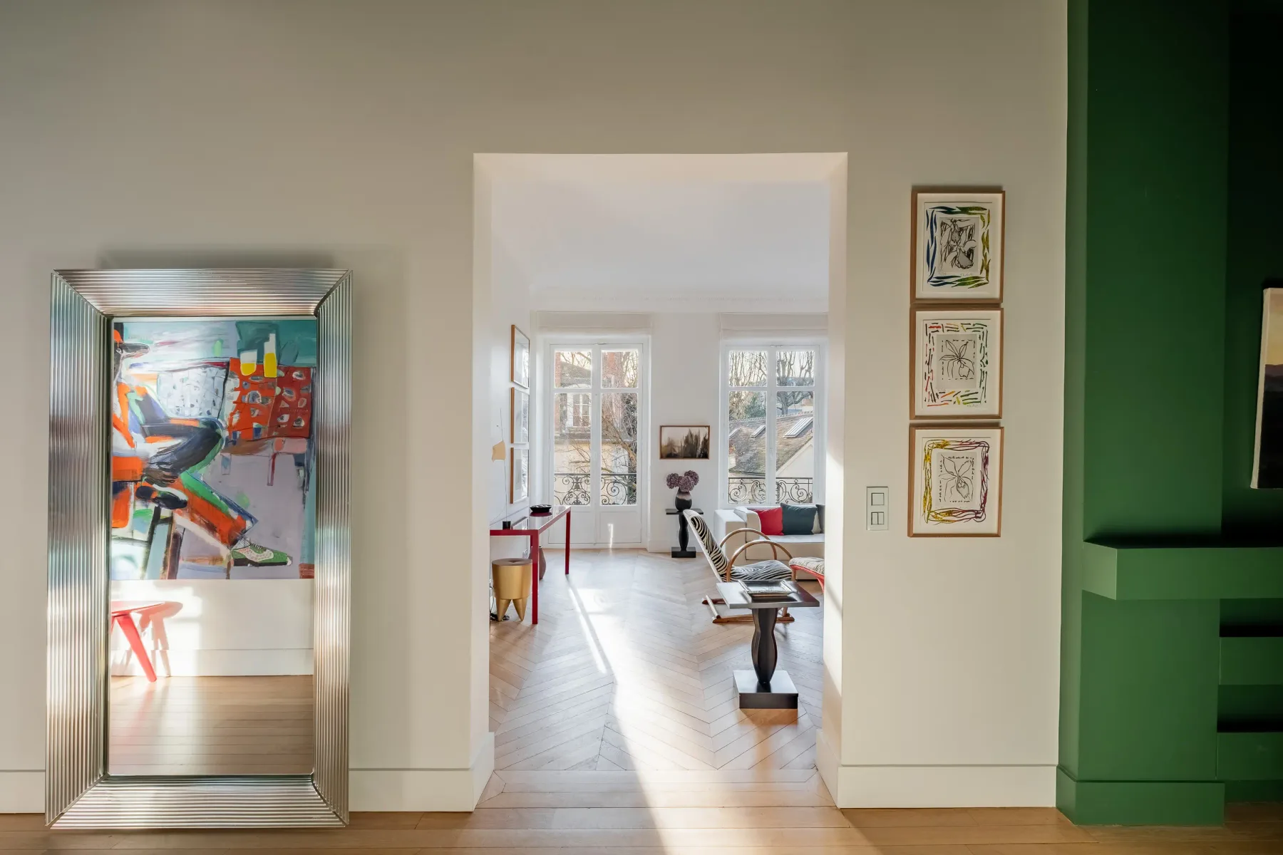 A bright living room is visible through a wide doorway, with colorful artwork on the wall.