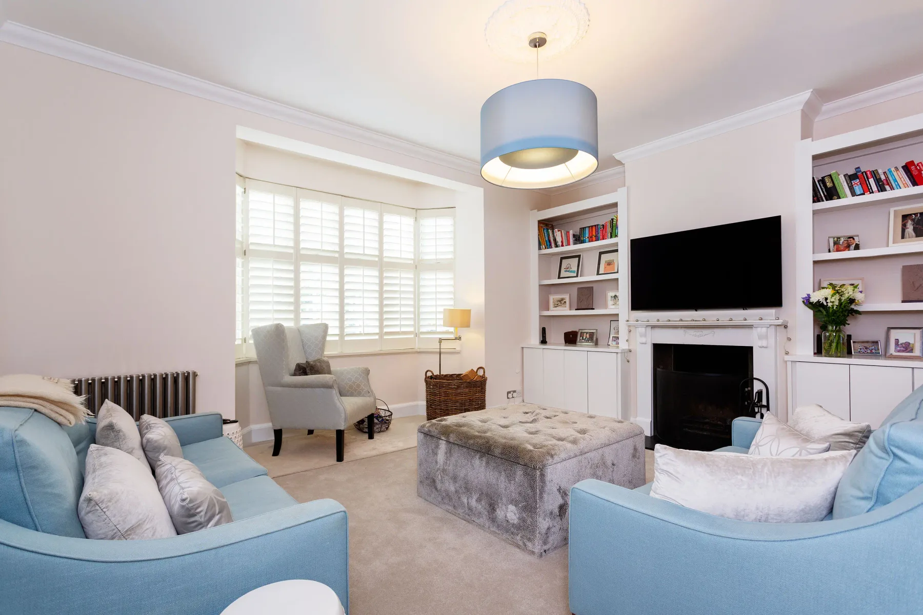 Living room with seating arranged around a coffee table and fireplace.
