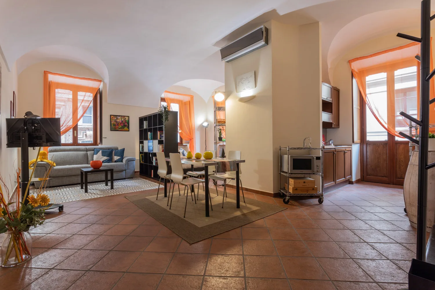 An open-plan living and dining room with a sofa and dining table.