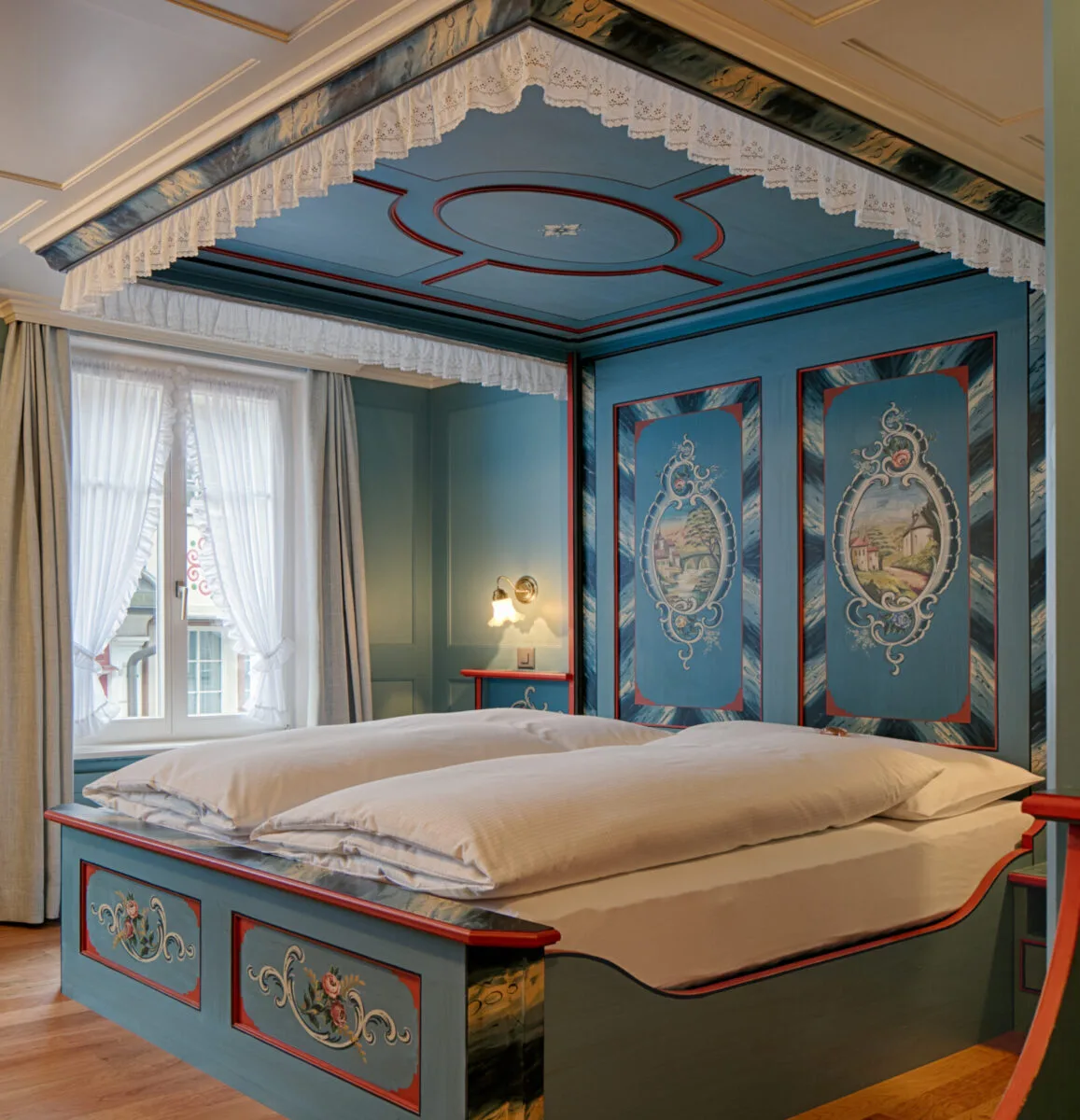 Traditional Double Room with a blue-painted four-poster bed.
