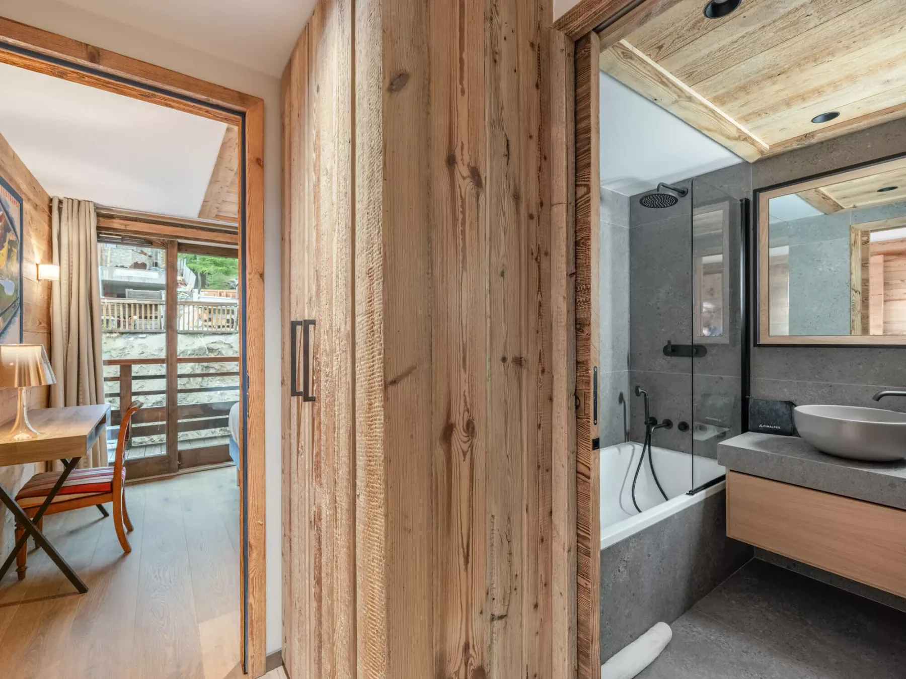 A wood-paneled interior hallway opens onto a bathroom with a vanity and shower.