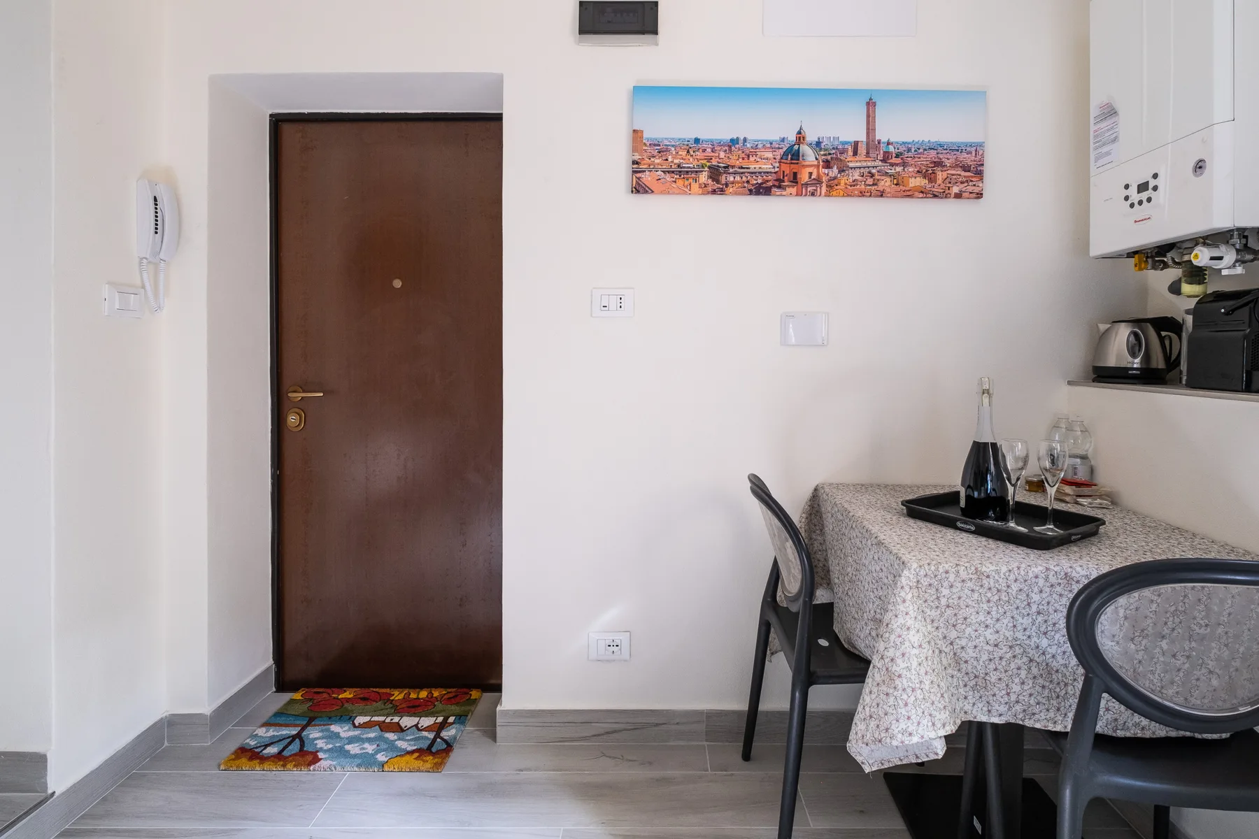A dining area with a table set beside a brown door.