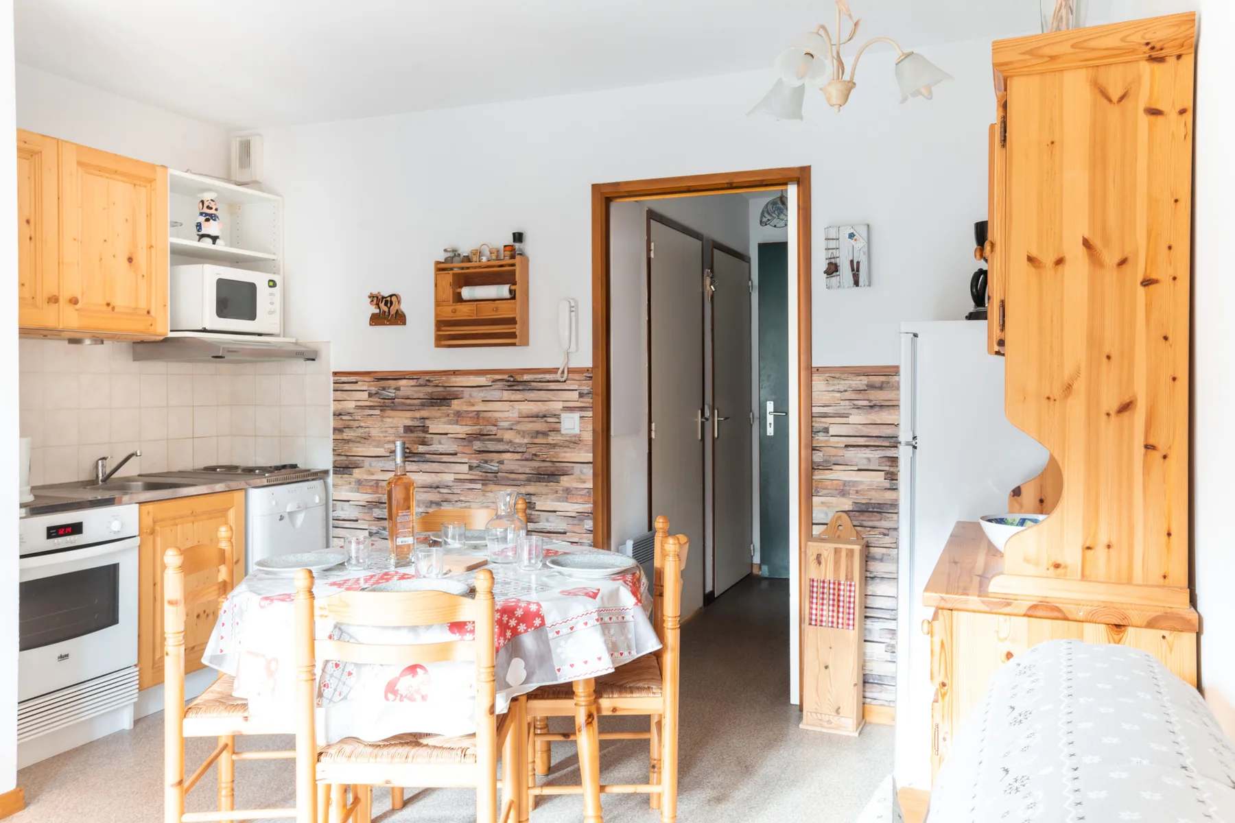A kitchen and dining area with a table set beside the cooking counter.