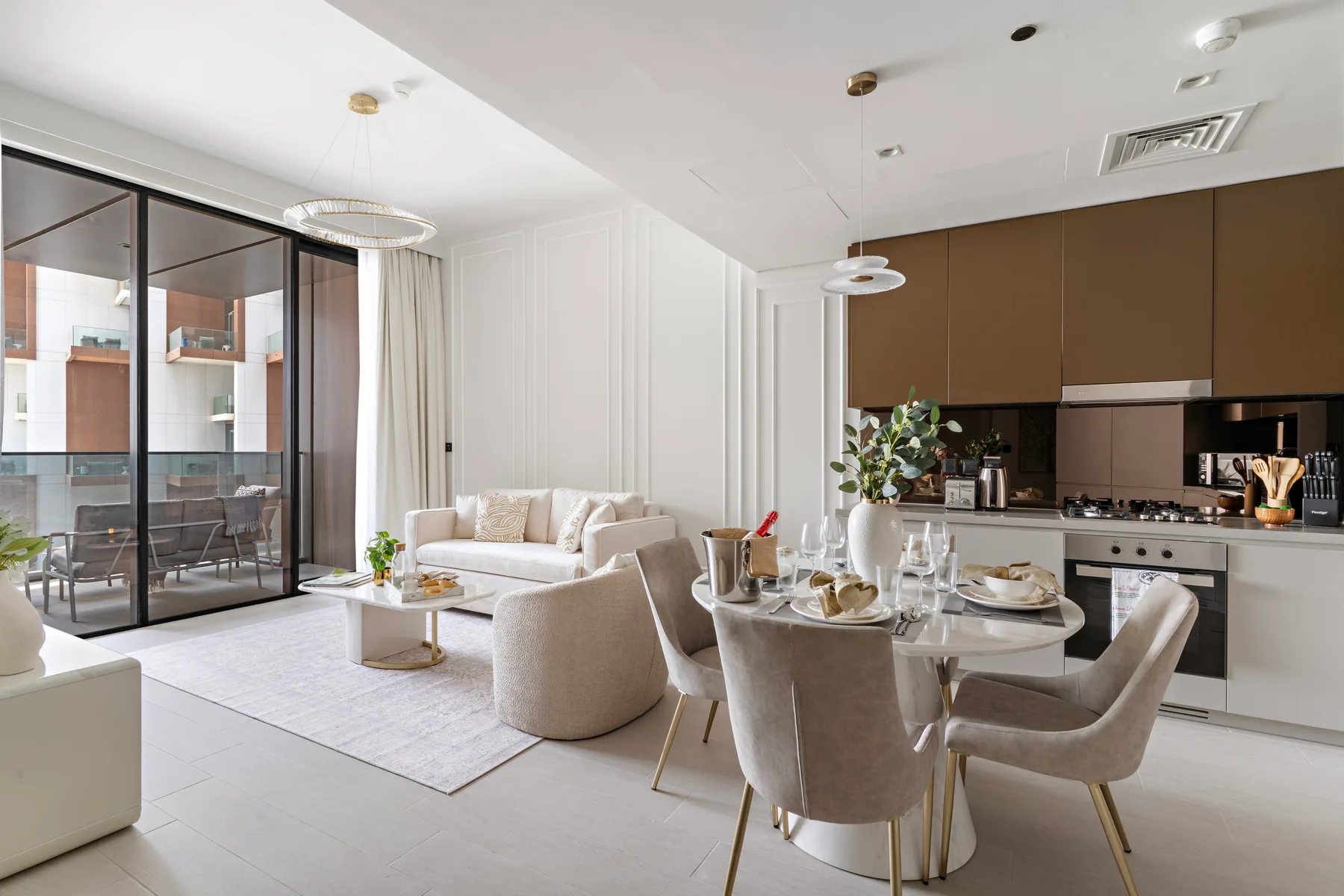 An open-plan living and dining area with a seating area beside the kitchen.