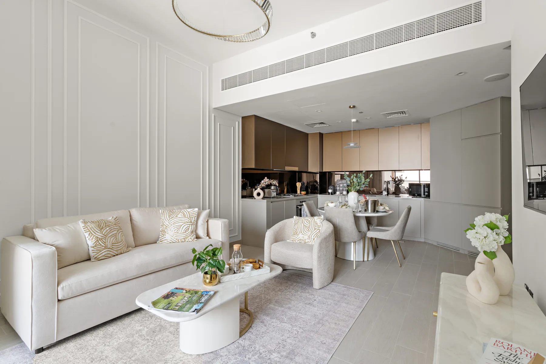 A bright living room opens into a dining area and kitchen.