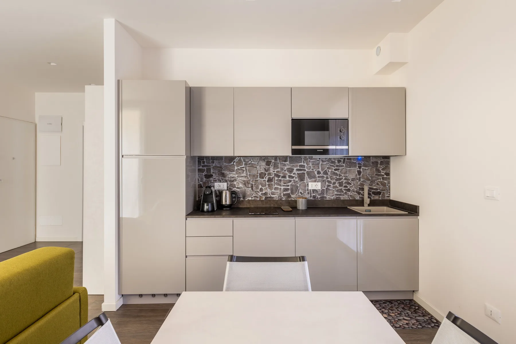 Una cocina moderna con gabinetes claros y un salpicadero estampado.