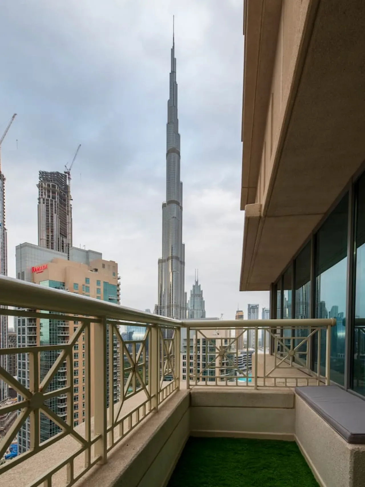 A rooftop terrace overlooks the Burj Khalifa and surrounding city skyline.