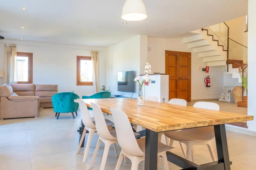 An open-plan living and dining area with a wooden table and seating.