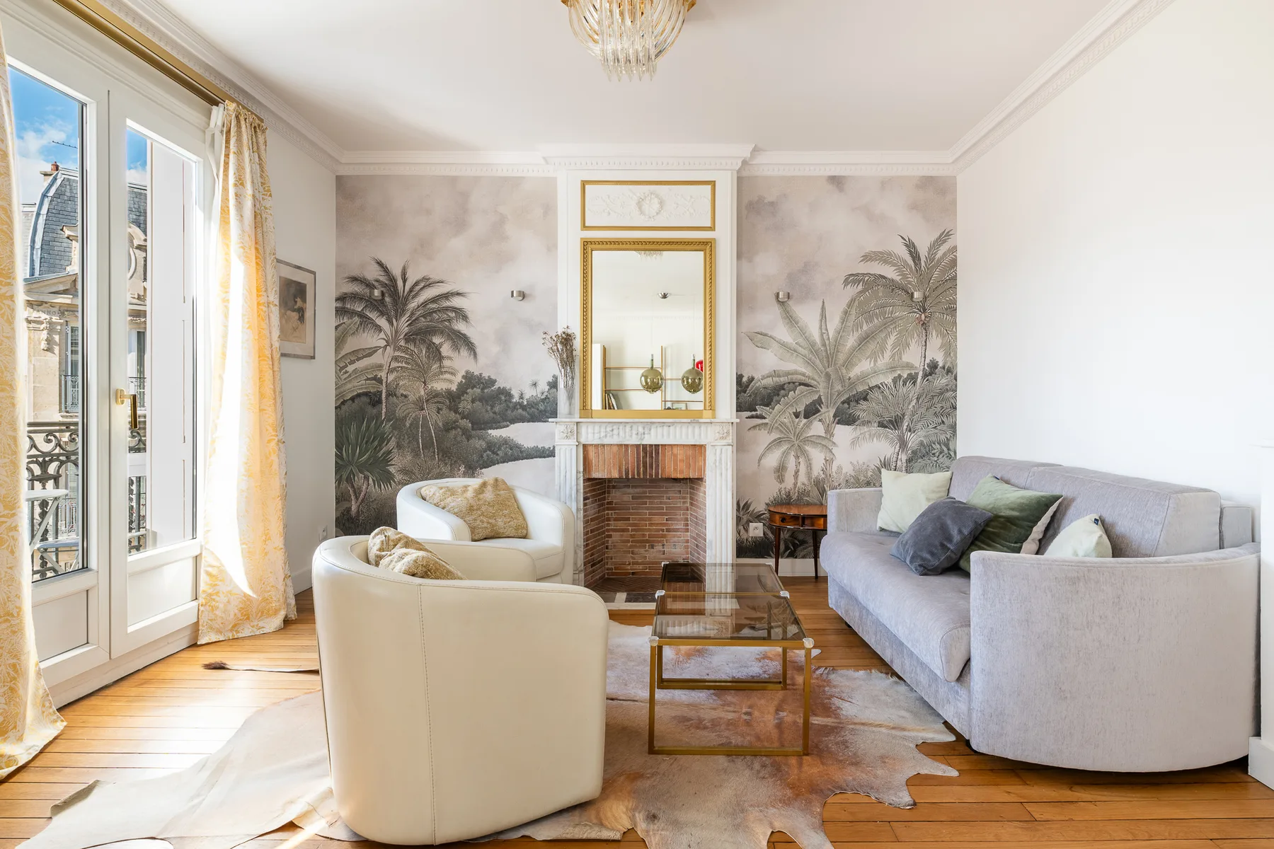 Living room with seating arranged around a coffee table and fireplace.