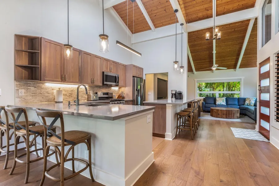 An open-plan kitchen and living area with a counter and seating.