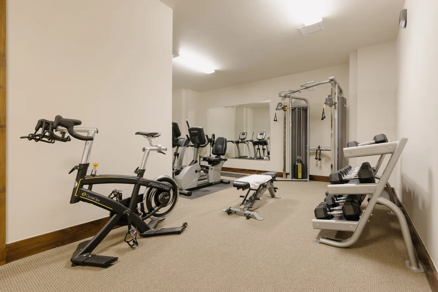 A fitness room with exercise equipment and weight machines.