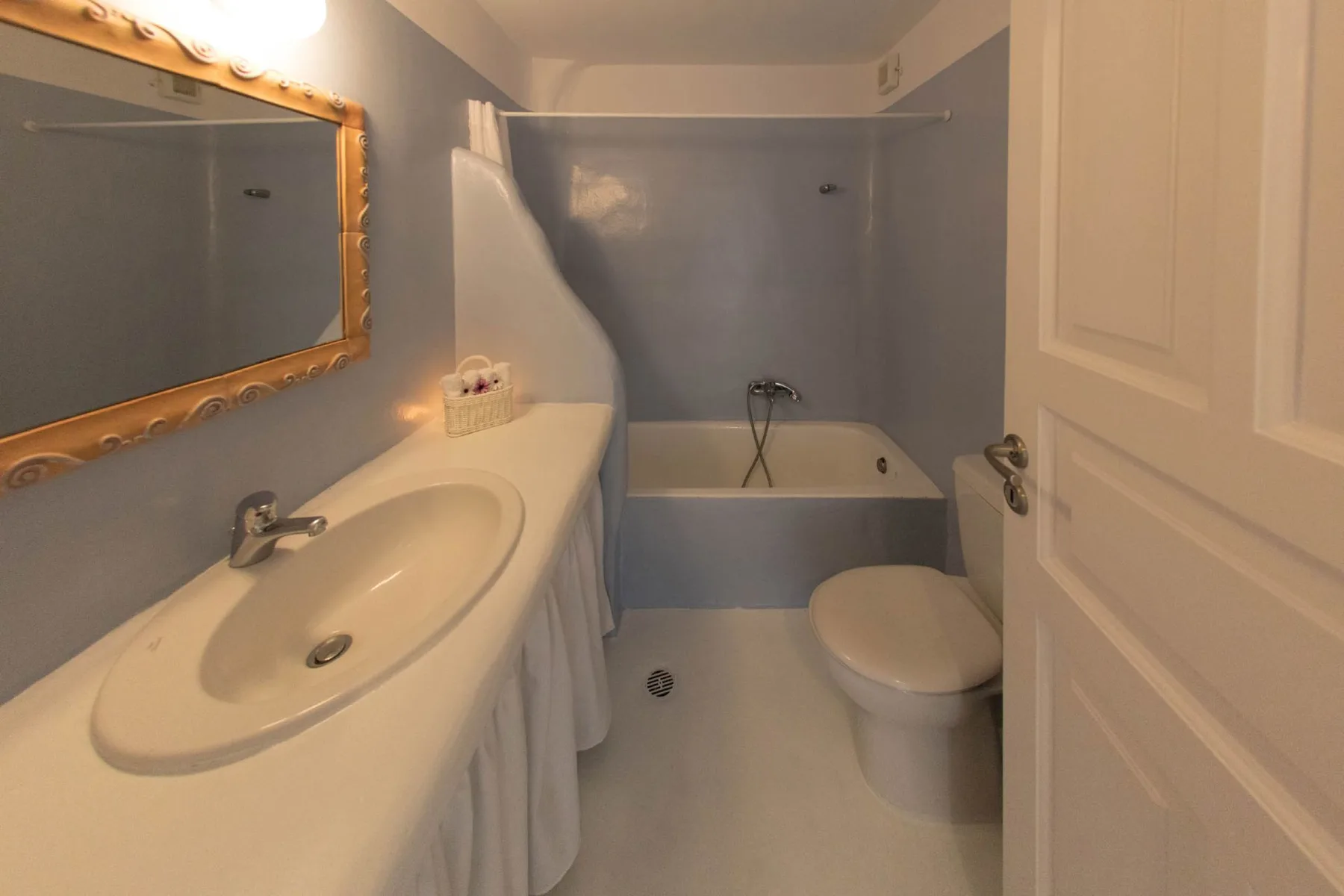 A bathroom with a sink, toilet, and bathtub.